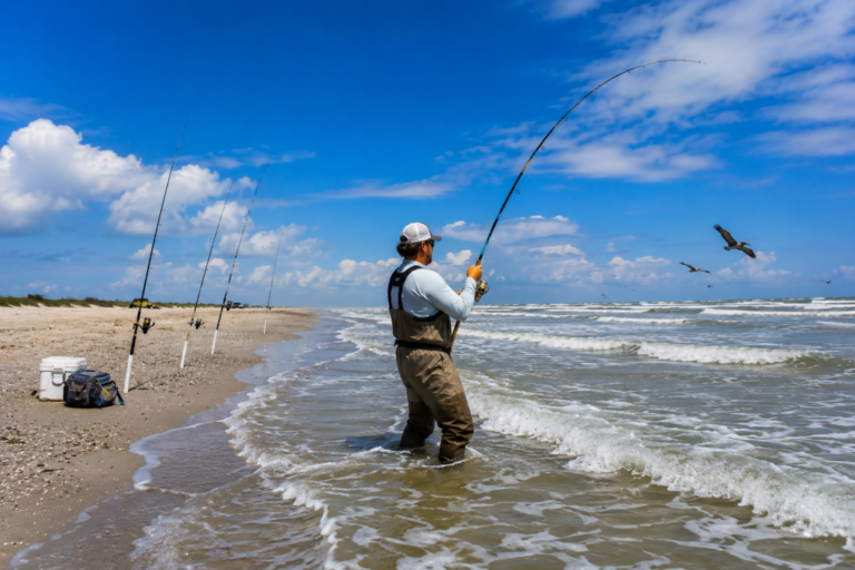 Surf fisherman fighting a fish in the Gulf of Mexico at Bolivar Peninsula on the Texas Gulf Coast