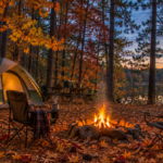 Fall campsite in the Southeast Texas Piney Woods with autumn leaves and campfire at dusk